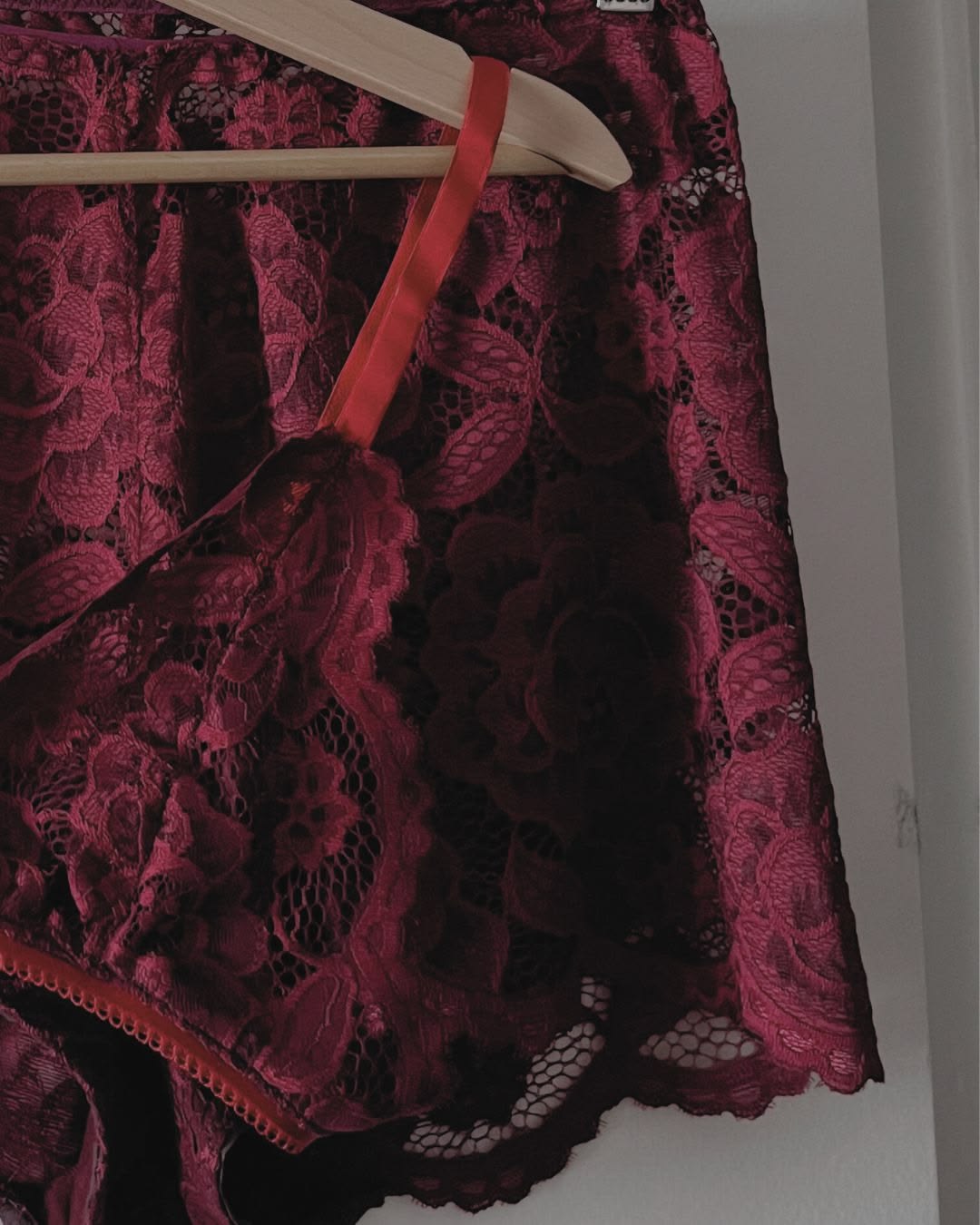 Burgundy lace and satin in low warm light